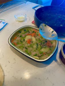 Ladling in duck pot pie filling